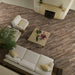 Soggiorno con camino e pavimento in gres porcellanato effetto legno rovere della collezione Hard & Soft di Ceramica Rondine, formato 15x100 cm, colore Soft Nut