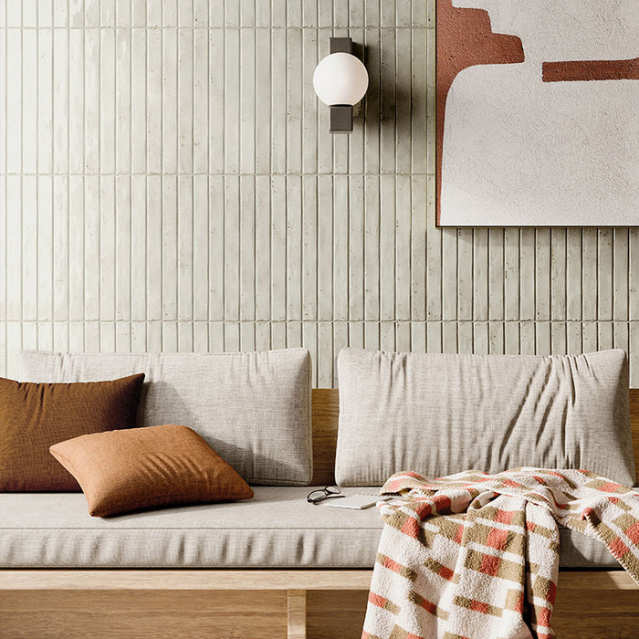 Salotto con rivestimento in gres porcellanato effetto mattoncino lucido 4.8x45 cm della collezione Colors Brick, colore Light Grey di Ceramica Rondine