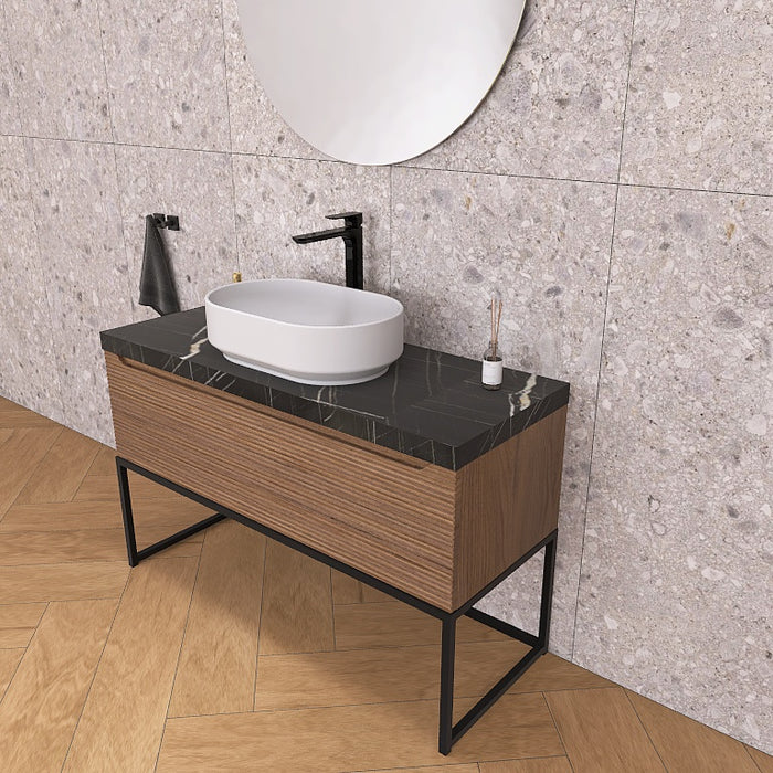 Un moderno mobile da bagno a terra, solido e di grande impatto visivo, grazie alla particolare cornice in metallo nero opaco, che crea un gioco di colore con la base cannettata orizzontale che contraddistingue la serie Penelope.
Altro filo conduttore della serie è il top scatolare nella particolare finitura marmo Nero marquinia.
Penelope 06 è un mobile audace e duraturo, che gioca con colori e materiali, al contempo elegante ed estremamente moderno.
Disponibile nelle finiture: Tortora Opaco, Bianco 