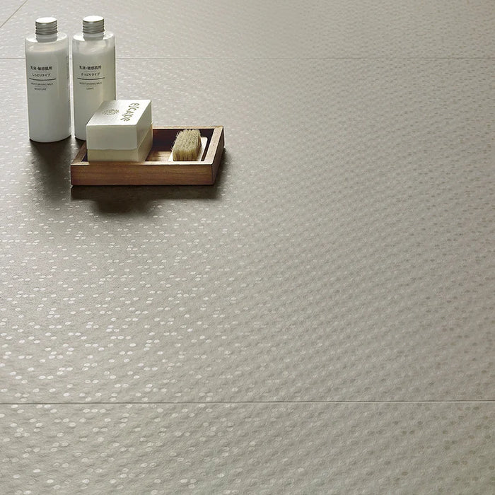 Dettaglio piastrella in gres porcellanato effetto materico con gocce lucide della collezione Aguas di Settecento Ceramica, colore Clay 90x90