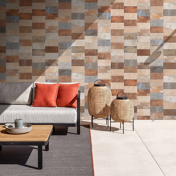 Esterno casa con divano e tavolino, soggiorno esterno, con rivestimento in gres porcellanato effetto cotto toscano della collezione Chianti di Keradom, formato 12.5x25 colore Multicolor per esterno antiscivolo R11