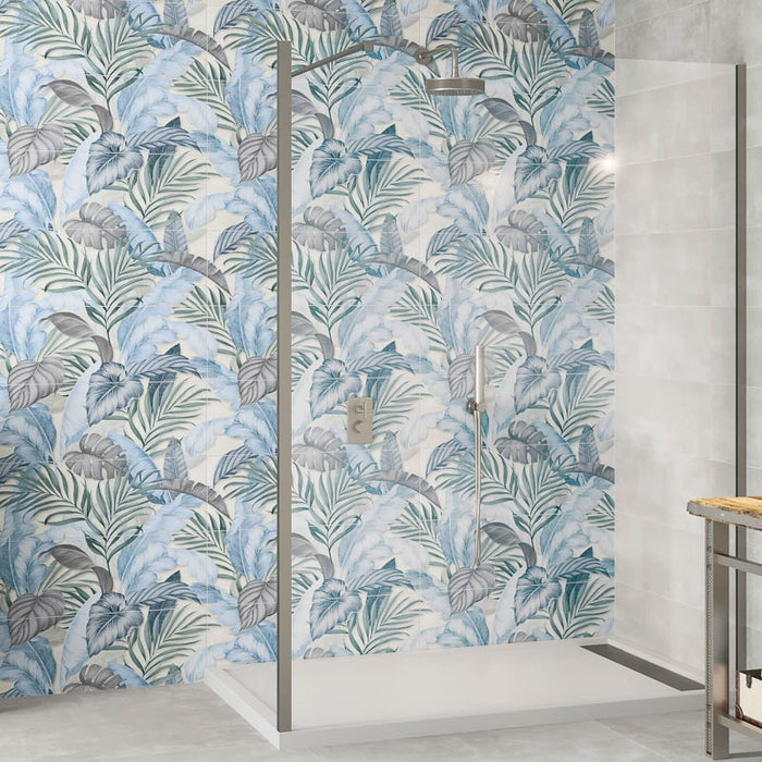 Dettaglio doccia walk in con profili cromati e muro con rivestimento effetto carta da parati con decoro floreale multicolore della collezione More Plus di Paul & Co Ceramiche, formato 25x75 rettificato, colore Forest Ice