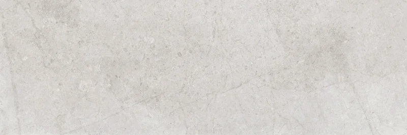 Piastrella per rivestimenti in bicottura pasta bianca effetto pietra della collezione Indira di Idea Ceramica, formato 33x100 cm, colore Grey
