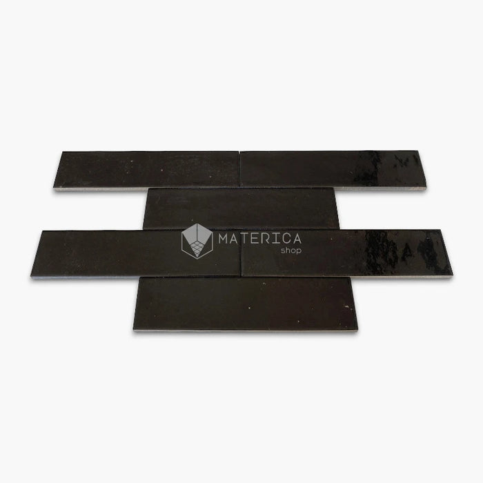 Rivestimento in gres porcellanato effetto mattoncino lucido 6x25 cm, collezione Soho Black di Ceramica Rondine. Piastrelle nere con posa a correre sfalsata per pareti di bagno e cucina.