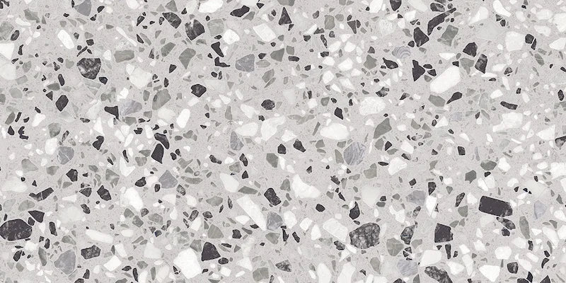 Dettaglio piastrella in gres porcellanato effetto graniglia e marmetta. Collezione Venexia di Alfalux, formato 30x60 cm, colore Tronchetto Grigio con marmette grigie, bianche e nere