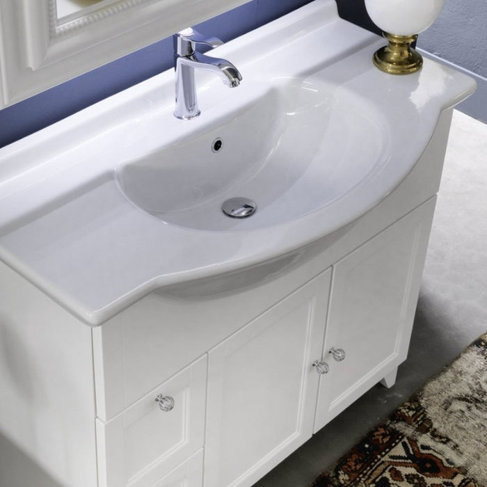 particolare di mobile bagno classico in finitura laccata bianco opaco con 2 ante e 2 cassetti, lavabo consolle semincasso in ceramica bianca e specchio rettangolare con cornice ad intarsi e fascia led integrata